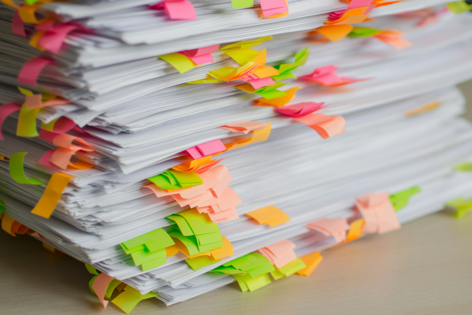 Stack of papers marked with colorful sticky tabs